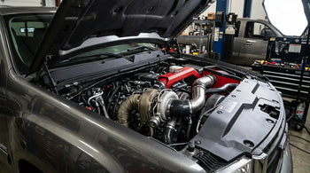 2011-2016 LML Duramax engine bay showing EGR system components targeted for off-road delete kit installation