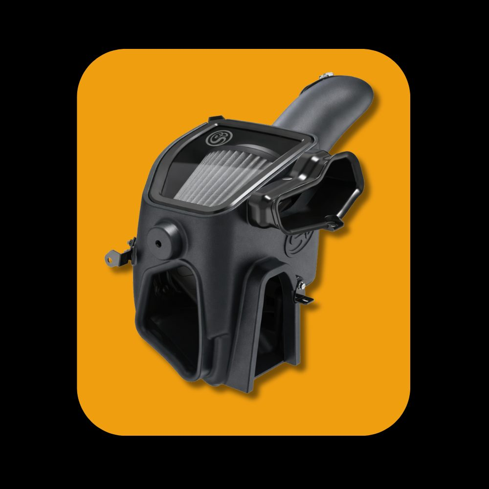 S&B cold air intake system installed on Ford 6.7L Powerstroke diesel engine, showing intake components and piping.